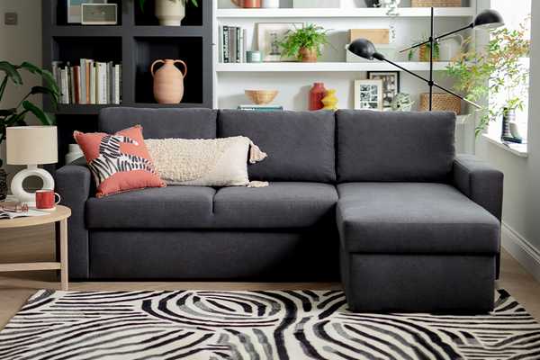 Argos Home Miller fabric corner chaise sofa bed in grey.